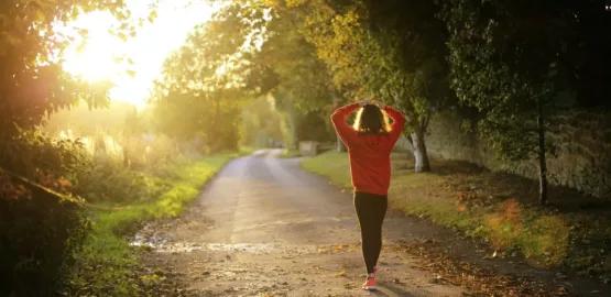 woman walking on pathway during daytime