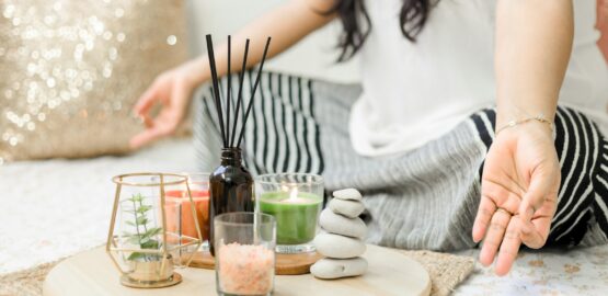 woman in white tank top holding black chopsticks